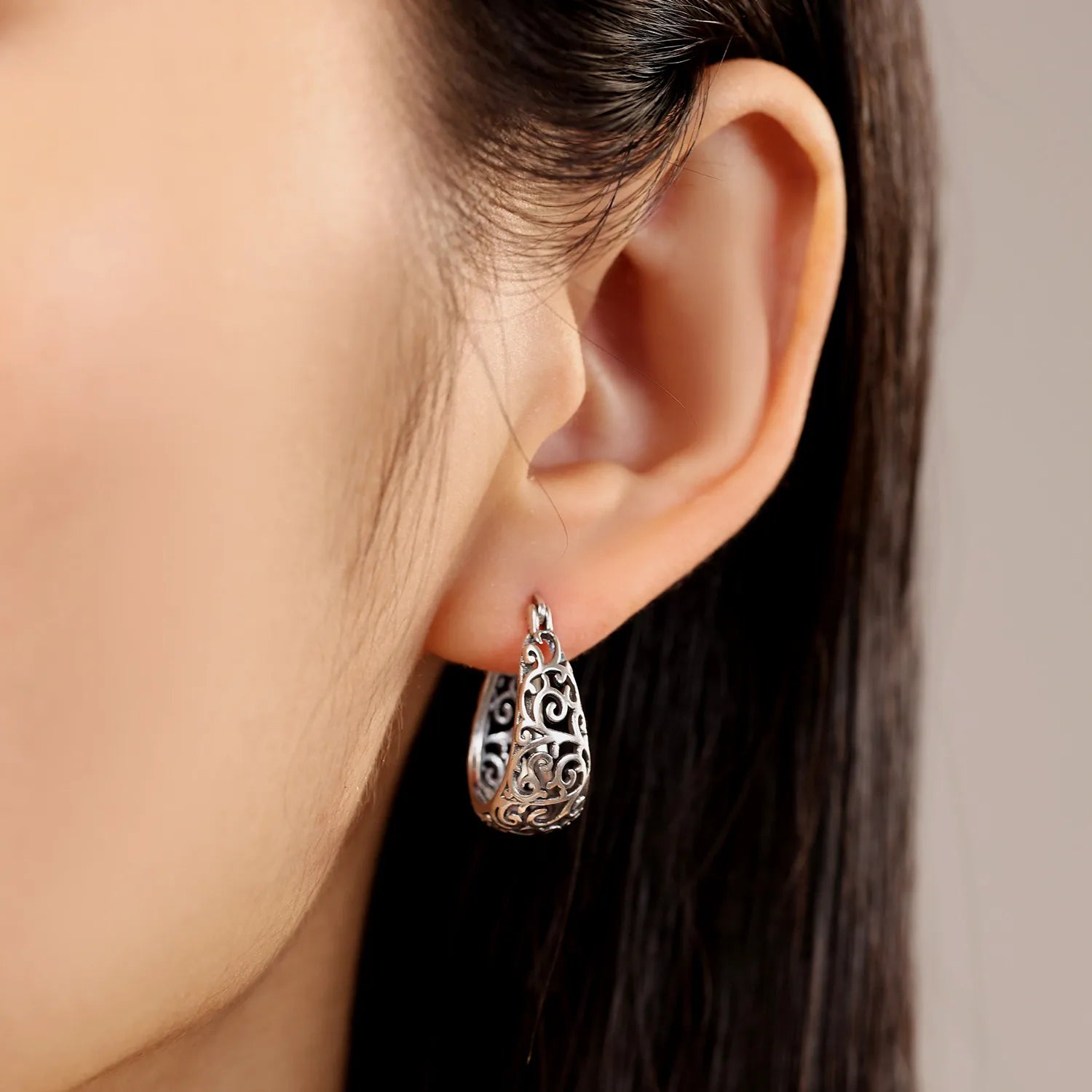 Vintage vine hoop earrings worn by a model, showcasing elegant fit and shine